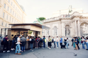 Eager patrons in line at Bitzinger Würstelstand, a beloved culinary destination near the Albertina and State Opera.