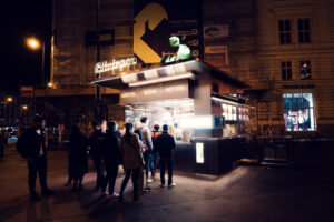 Bitzinger Würstelstand bustling with activity, as people line up for a taste of Vienna's street food.