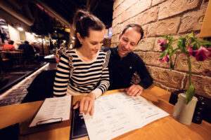 Adriana and Mario looking at the menu at Figls restaurant.