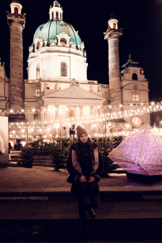 Adriana in front of St. Charles Church (Karlskirche) during the Christmas market season.