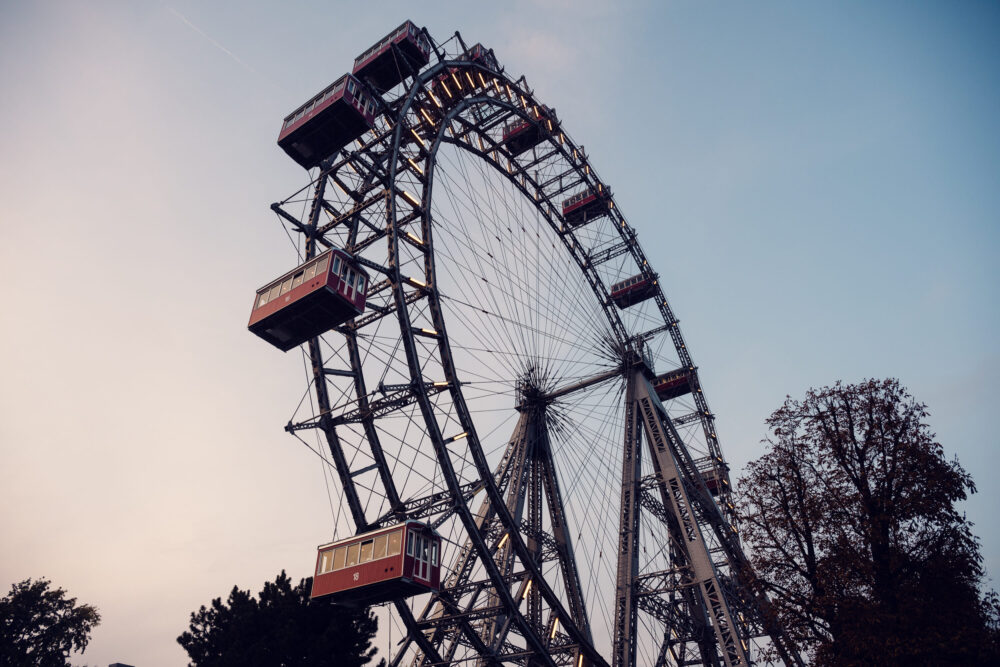 Historic Vienna Giant Ferris Wheel (Wiener Riesenrad) standing tall against a clear blue sky, a symbol of Prater's charm.