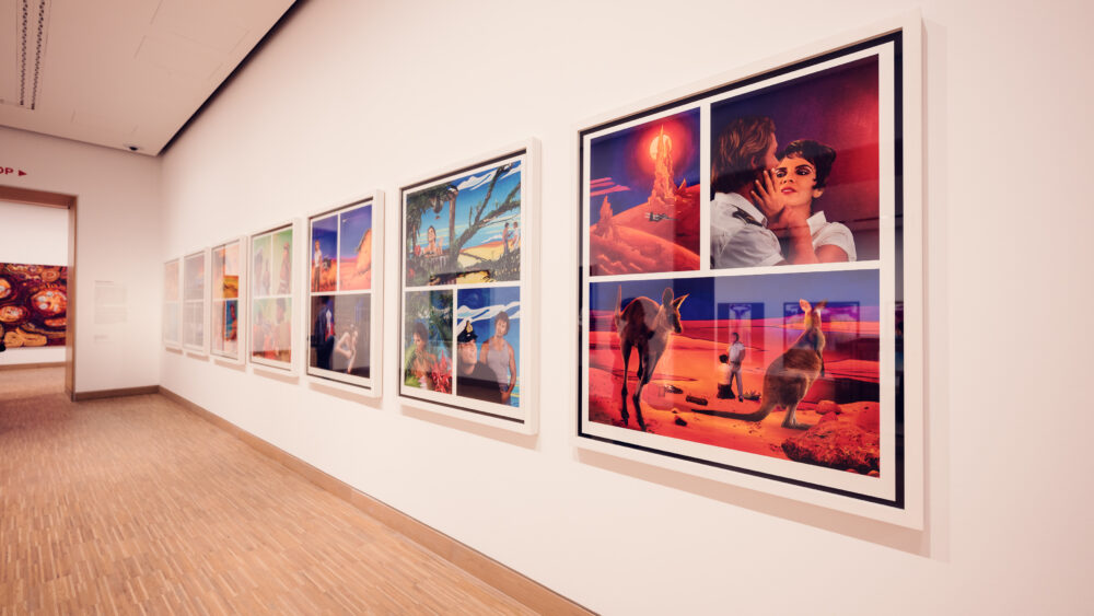 A brightly lit gallery at Albertina Modern museum, featuring a series of colorful, surrealist paintings along the wall