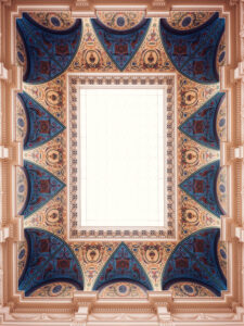 The ornate ceiling of Albertina Modern museum, featuring intricate geometric designs in blue, gold and red.