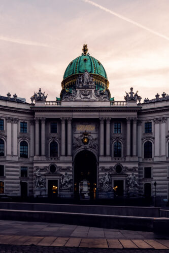 Stunning view of Hofburg Palace from Kohlmarkt, highlighting its grand architecture.