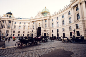 Elegant fiaker parked outside Hofburg Palace, showcasing Vienna's historic charm.