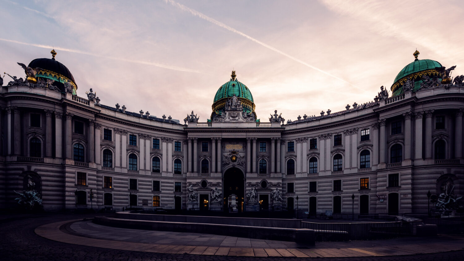 Panoramic view of Hofburg Palace from Kohlmarkt, capturing its regal presence in Vienna.