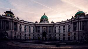 Panoramic view of Hofburg Palace from Kohlmarkt, capturing its regal presence in Vienna.