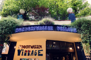 The entrance doorway leads visitors through Hundertwasser's fantastical world, while multicolored pillars seem to dance along the pathway.