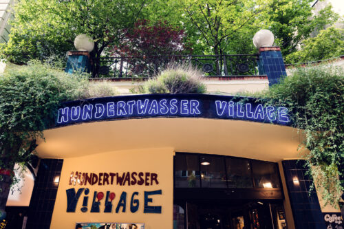 The entrance doorway leads visitors through Hundertwasser's fantastical world, while multicolored pillars seem to dance along the pathway.