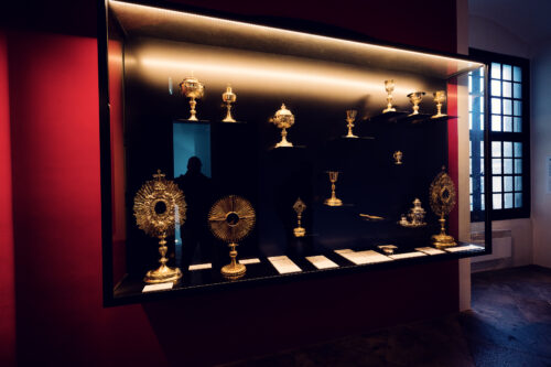 A collection of ornate religious artifacts, including chalices and monstrances