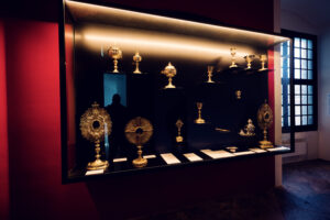 A collection of ornate religious artifacts at Karlskirche, including chalices and monstrances at St. Charles Church (Karlskirche).