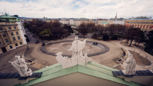 The rooftop view from St. Charles Church (Karlskirche), overlooking the surrounding plaza and cityscape of Vienna.