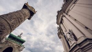 One of the ornate columns and the exterior facade of St. Charles Church (Karlskirche) in Vienna.