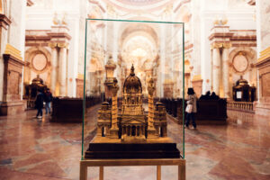 A detailed scale model of St. Charles Church (Karlskirche) encased in glass