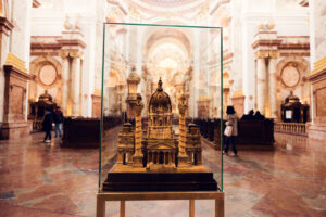 A detailed scale model of St. Charles Church (Karlskirche) encased in glass.