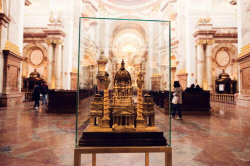 A detailed scale model of St. Charles Church (Karlskirche) encased in glass.