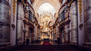 The grand interior of St. Charles Church (Karlskirche) in Vienna, highlighting its ornate baroque design.