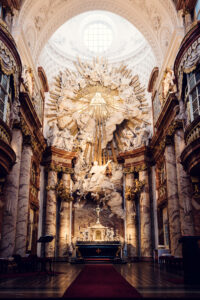 The breathtaking interior of St. Charles Church (Karlskirche) in Vienna, featuring an intricately detailed altar with a stunning baroque design