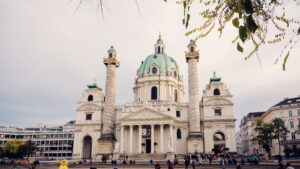 The architectural details, including the statues and portico, emphasize the St. Charles Church (karlskirche) impressive design