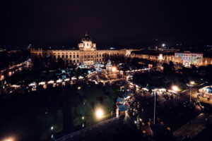 The Kunsthistorisches Museum Vienna by night, with the Christmas market in front on Maria-Theresien-Platz.