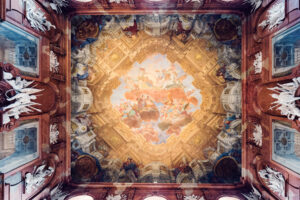 Gilded ceiling masterpiece in Lower Belvedere's room featuring intricate Baroque frescoes and ornamental details.