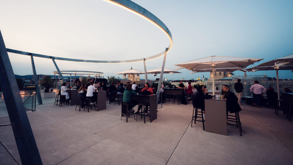 People enjoying terrace at MQ Libelle Vienna with outdoor seating and relaxed atmosphere at Museumsquartier.