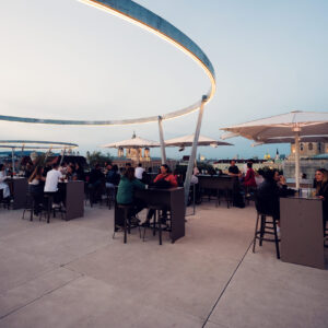 People enjoying terrace at MQ Libelle Vienna with outdoor seating and relaxed atmosphere at Museumsquartier.