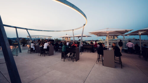 People enjoying terrace at MQ Libelle Vienna with outdoor seating and relaxed atmosphere at Museumsquartier.