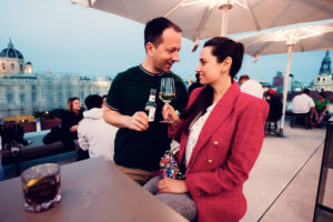 Adriana and Mario cheering with glasses at MQ Libelle Vienna.