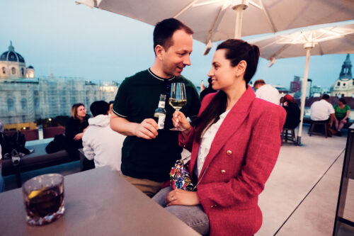 Adriana and Mario cheering with glasses at MQ Libelle Vienna.