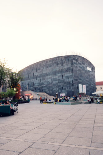 Corner view of MUMOK Vienna's angular basalt cube structure rising from the MuseumsQuartier courtyard, housing over 10,000 modern and contemporary artworks.