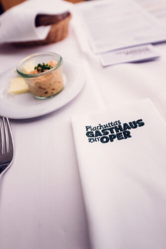 Refined dining experience at Plachutta zur Oper, where thoughtfully arranged place settings showcase Viennese restaurant excellence.