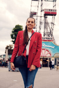 Adriana in front of the majestic Giant Ferris Wheel (Wiener Riesenrad).
