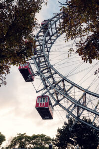 Red cabins of the Giant Ferris Wheel (Wiener Riesenrad) glowing in golden hour light.