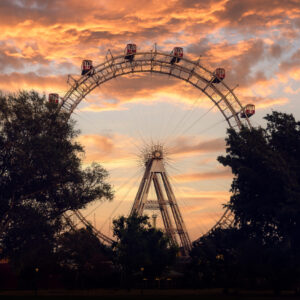 Golden hour light illuminating the historic Giant Ferris Wheel's (Wiener Riesenrad) distinctive silhouette.