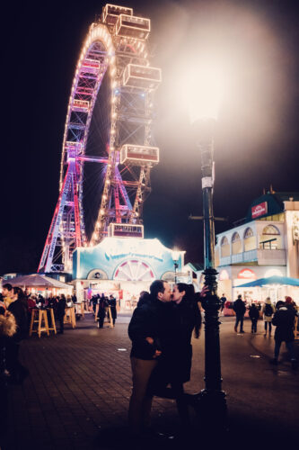 Evening view of Vienna's iconic Giant Ferris Wheel (Wiener Riesenrad), its lights twinkling like stars in the urban landscape.