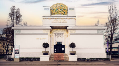 Vienna Secession Building entrance with ornate Art Nouveau details and the golden dome visible from Friedrichstraße.
