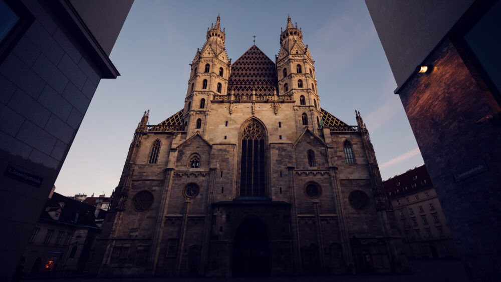 Morning light illuminating the St. Stephen's Cathedral intricate stone facade, perfect for architectural photography.