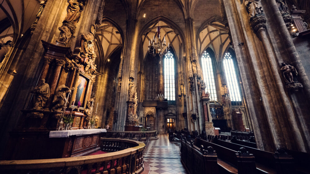 Atmospheric interior lighting creating spiritual ambiance at the St. Stephen's Cathedral.