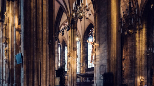 Majestic columns inside St. Stephen's Cathedral, their Gothic architecture creating an interplay of light and shadow.