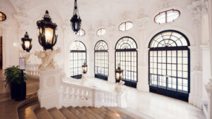 Grand staircase at Belvedere Castle with baroque balustrade and frescoes.