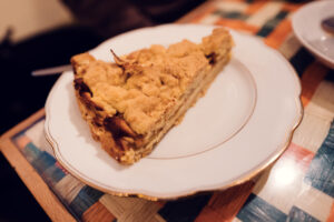 A slice of Vollpension's classic Grandma’s apple cake, served on a vintage white plate