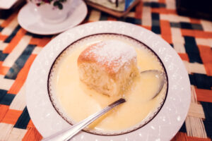 Vollpension's famous Buchtel, a soft, fluffy Austrian sweet roll, served in a generous pool of warm vanilla sauce