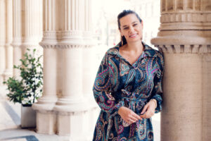 Elegant pose at the iconic columns of the Vienna State Opera, perfect for photography.