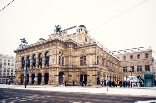 Snow-covered Vienna State Opera creating a magical winter scene.