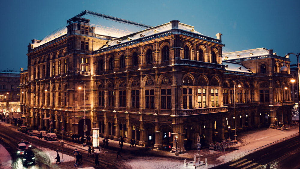 Vienna State Opera in winter, its grand architecture enhanced by a pristine blanket of snow, offering a stunning photo opportunity.