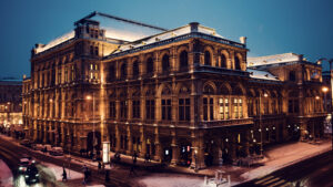 Vienna State Opera in winter, its grand architecture enhanced by a pristine blanket of snow, offering a stunning photo opportunity.
