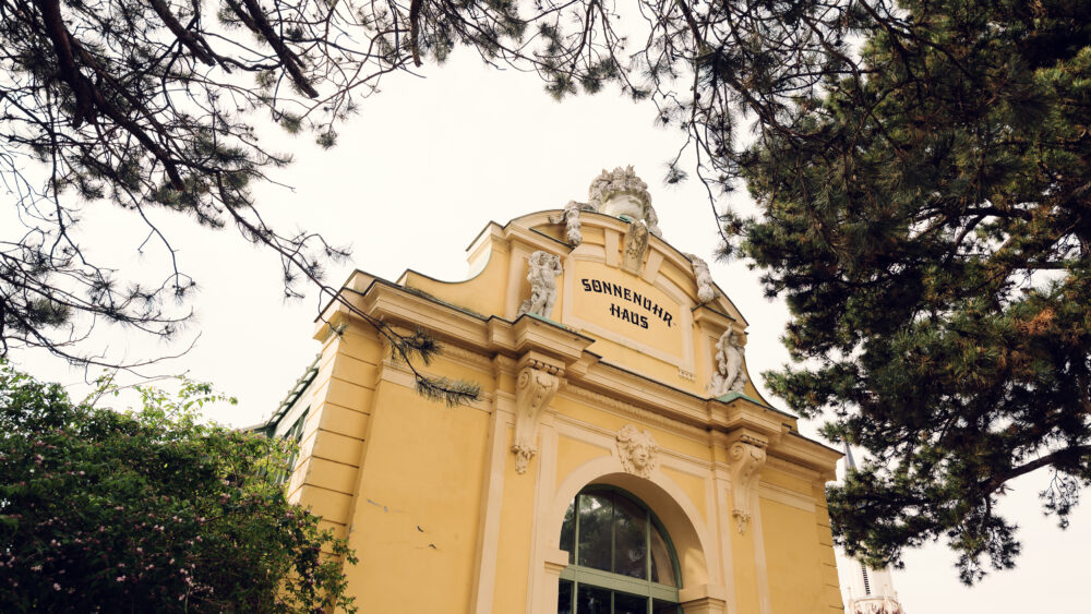 The entrance to the Desert House Schönbrunn stands tall and inviting.