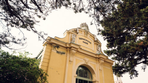 The entrance to the Desert House Schönbrunn stands tall and inviting.