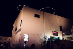 Modern Leopold Museum exterior in MuseumsQuartier displaying striking limestone architecture against historic buildings.